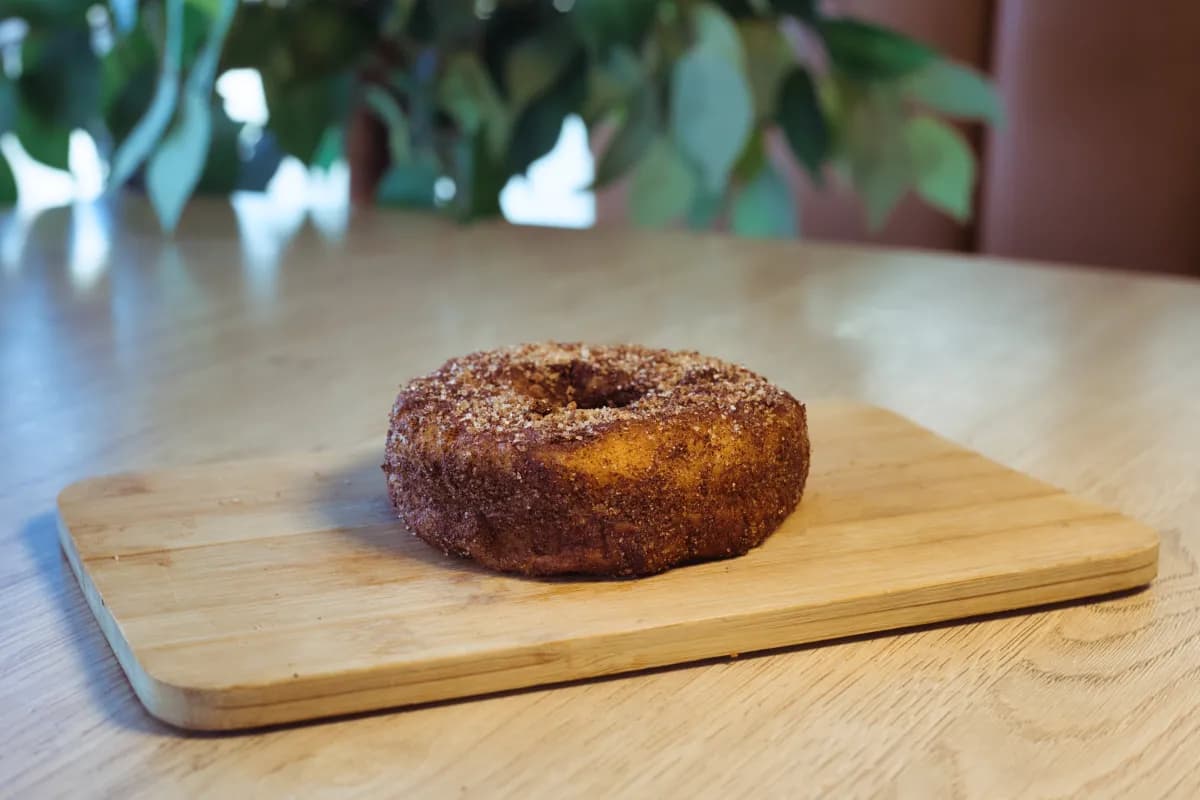 Cinnamon sugar doughnut on a wooden board
