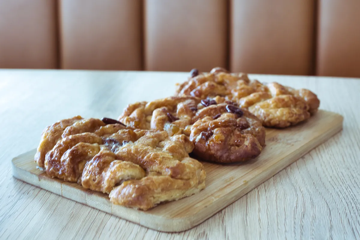 Golden pecan danishes on a wooden board