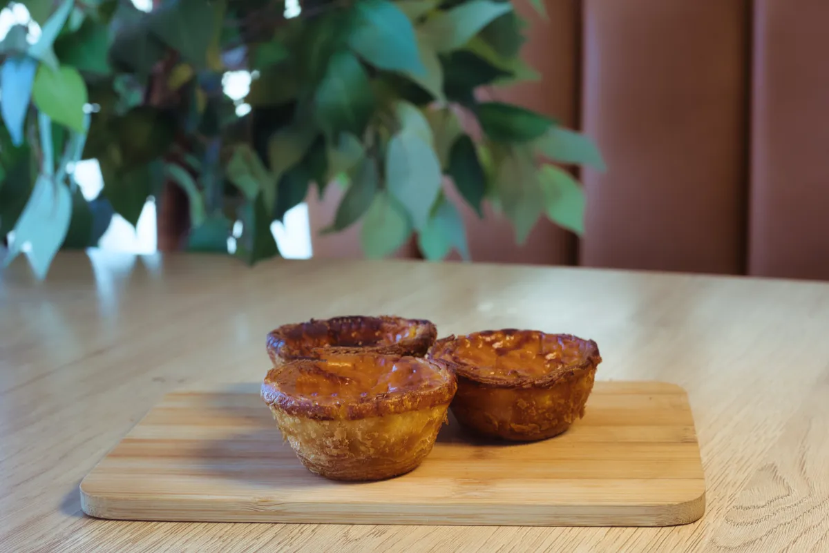 Caramelised pecan tarts on a wooden board